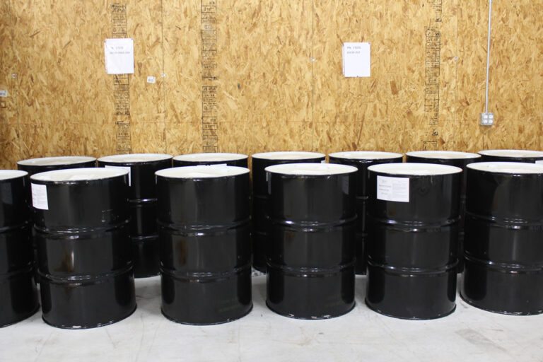 Lube oil drums stocked for compressor maintenance, oil changes, and gas processing equipment service.