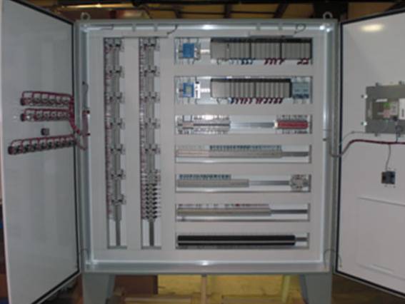 Open industrial control panel with PLC modules, terminal blocks, wiring, and automation components for gas processing systems.