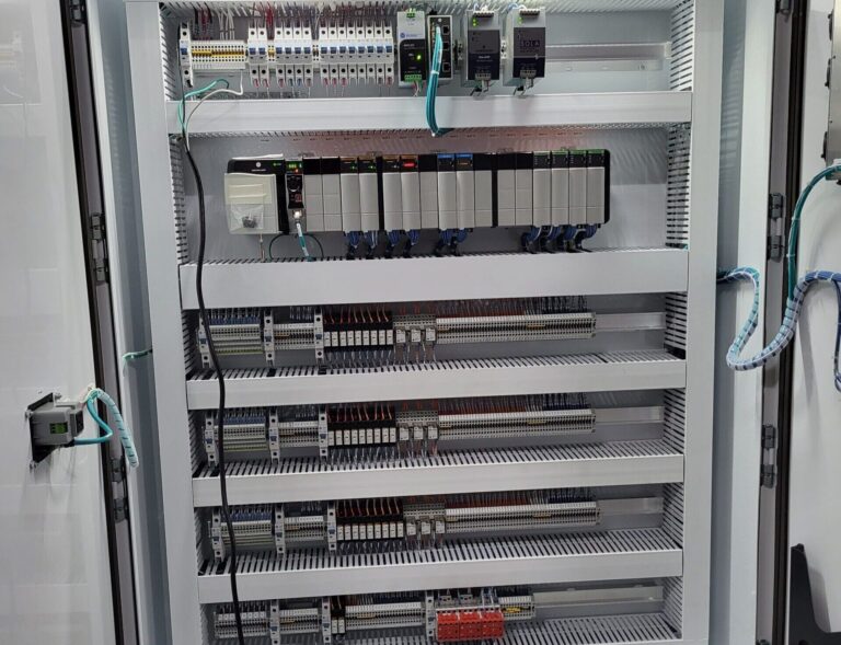 Industrial control panel with PLC modules, wiring, relays, and automation components for gas processing control systems.
